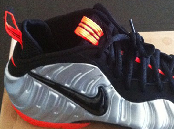 silver black and orange foamposites