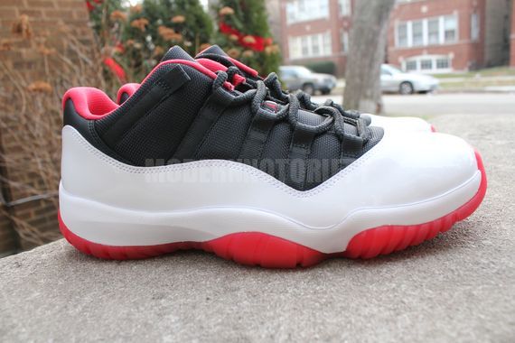 red black and white low top jordans 11