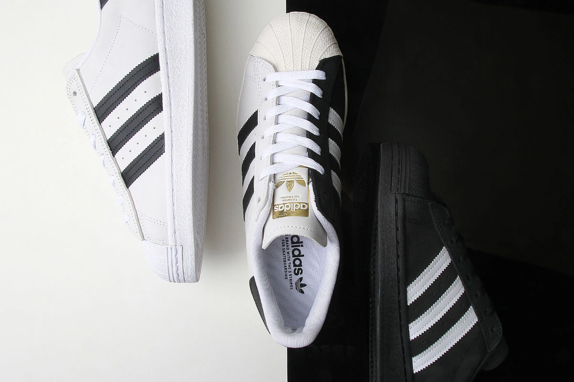 adidas white shoes with black stripes on one side