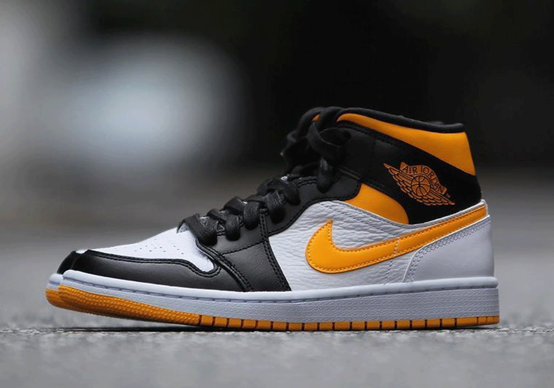 black and yellow mid jordan 1s