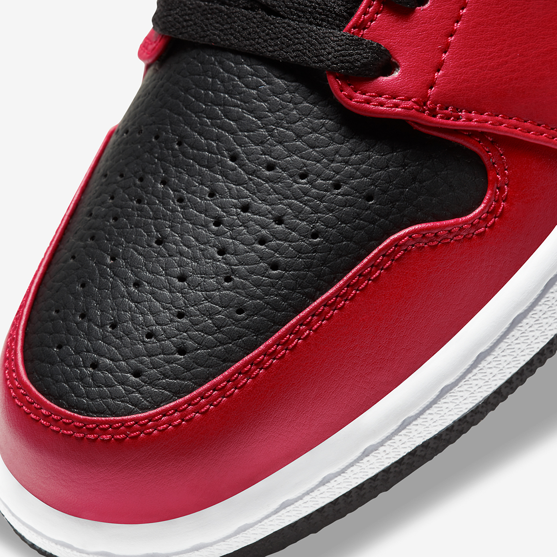 Tumbled leathers appear on this inverted Air Jordan 1 Low "Banned"