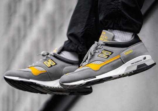 The New Balance 1500 Pairs A Solid Grey With Speed Yellow Accents