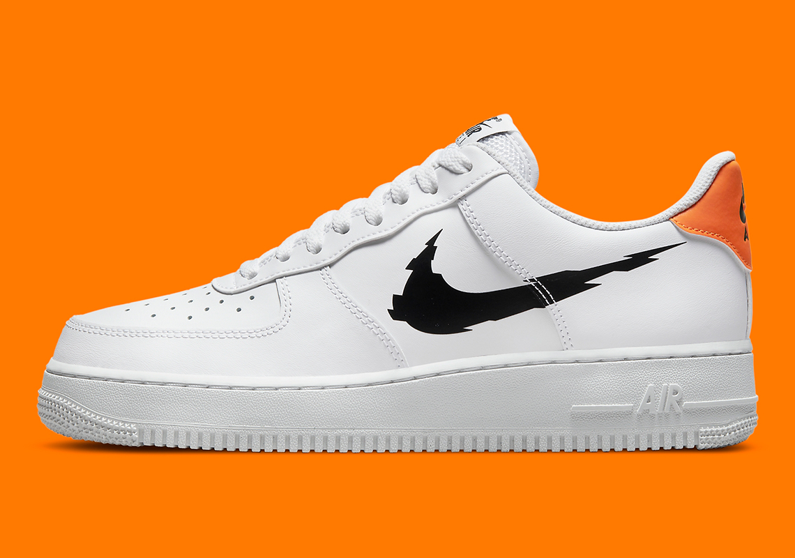 white and black air forces with orange lettering