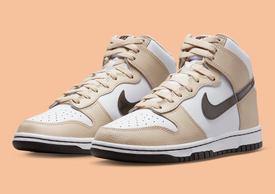 The Nike Dunk High Pairs Tumbled Tan Leather With Brown Patent Swooshes